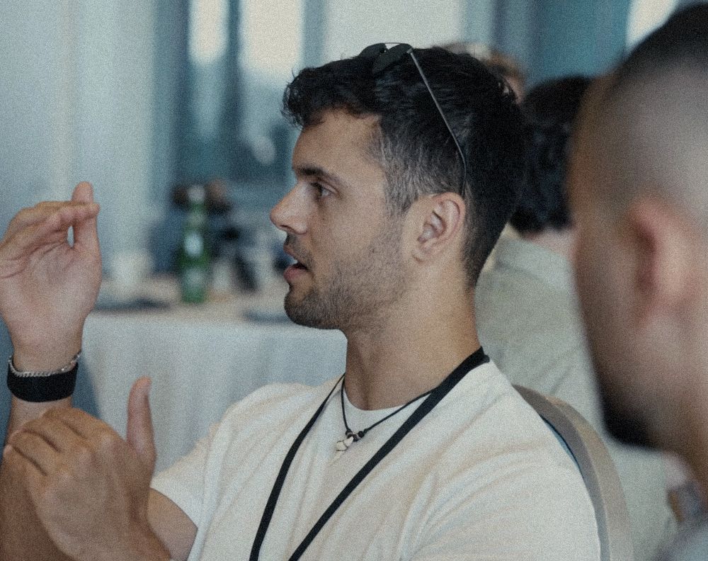 Ethan Monkhouse mid-conversation at a conference table