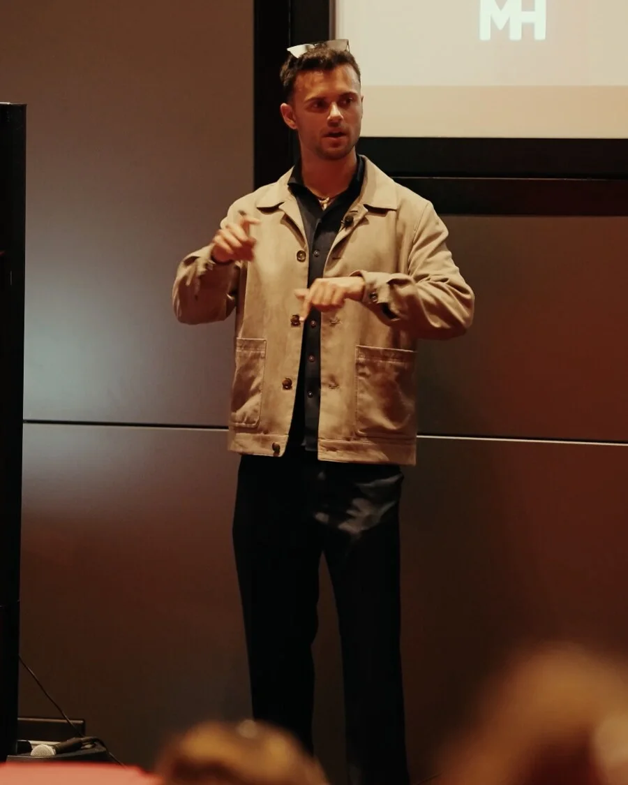 Ethan Monkhouse. Mid-explanation on stage